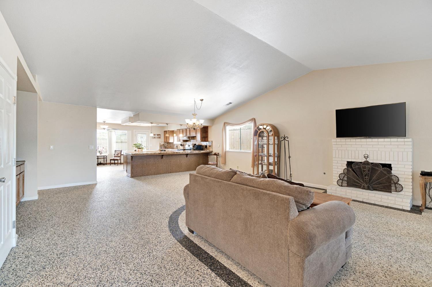 73 Devon Drive Lemoore, CA 93245 - Photo 12 of 32 a living room with furniture and a flat screen tv
