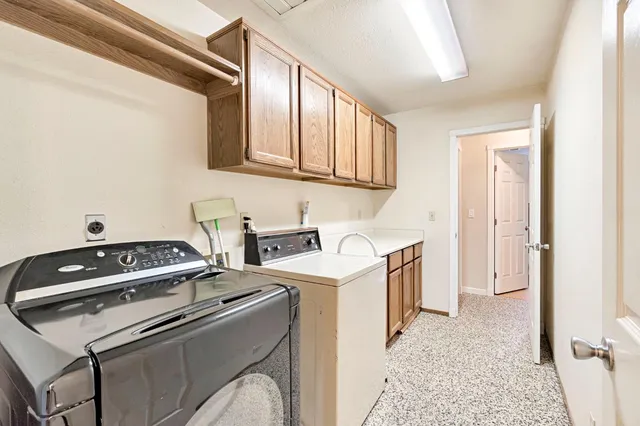 a view of a room with wooden floor and ceiling fan