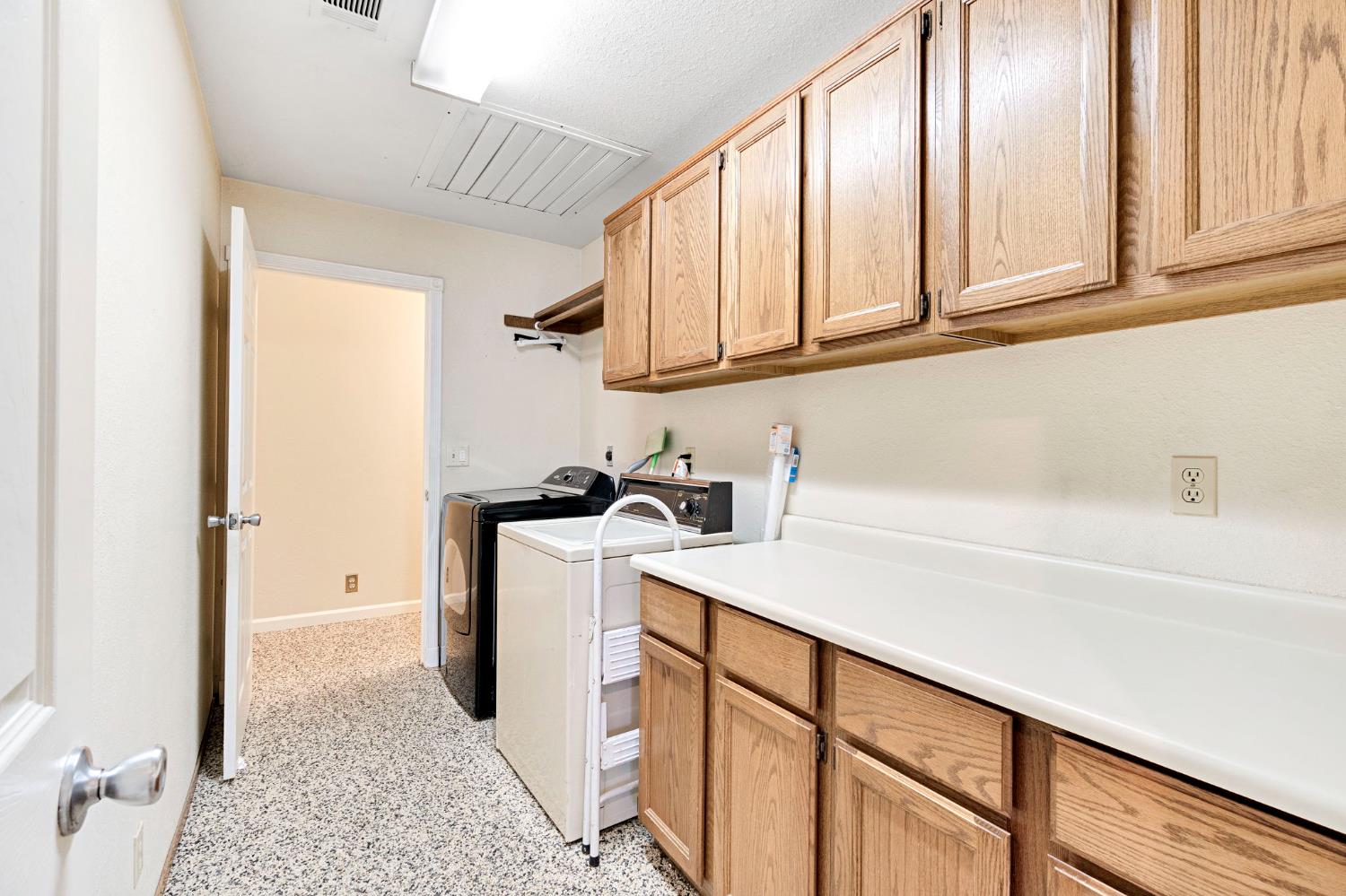 73 Devon Drive Lemoore, CA 93245 - Photo 18 of 32 a view of a kitchen with fridge and wooden floor