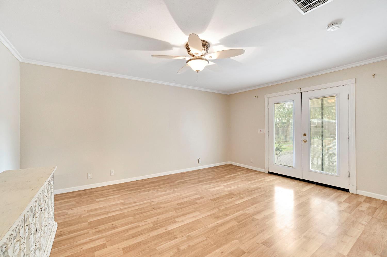 73 Devon Drive Lemoore, CA 93245 - Photo 19 of 32 wooden floor in an empty room with a window
