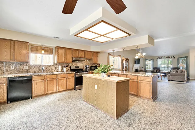 a kitchen with stainless steel appliances granite countertop a sink and cabinets