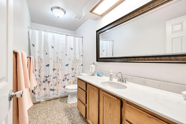 a bedroom with a bed and ceiling fan