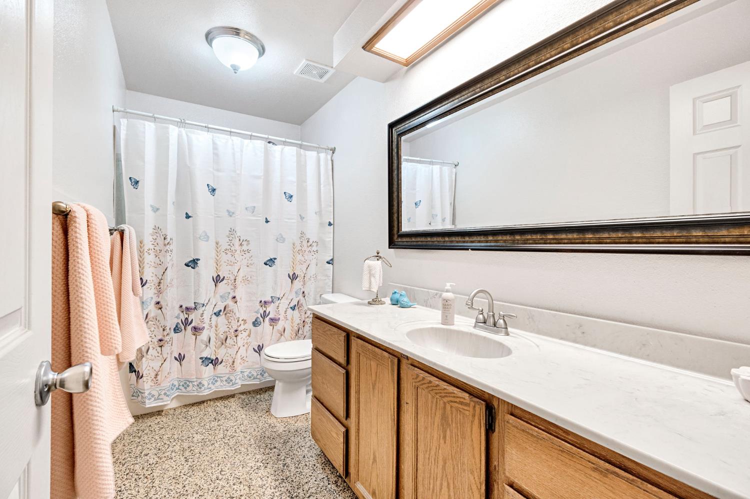 73 Devon Drive Lemoore, CA 93245 - Photo 23 of 32 a bathroom with a sink a toilet and a shower