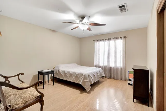 a view of a chair and table in backyard of the house