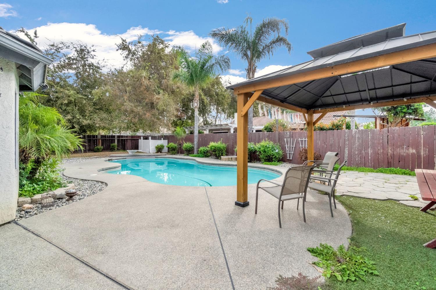 73 Devon Drive Lemoore, CA 93245 - Photo 27 of 32 a view of a backyard with sitting area furniture and garden