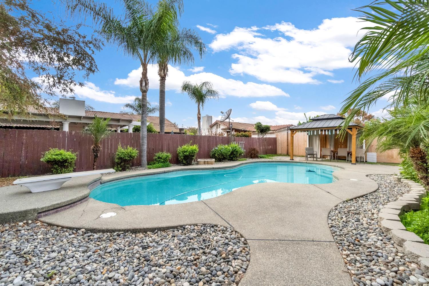 73 Devon Drive Lemoore, CA 93245 - Photo 29 of 32 a view of a house with a yard and sitting area