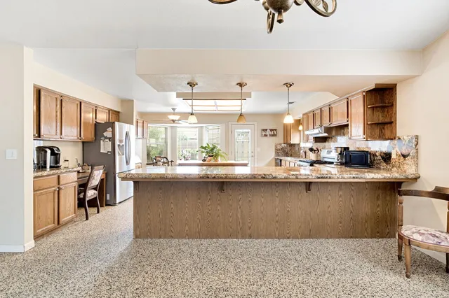 a kitchen with stove and cabinets