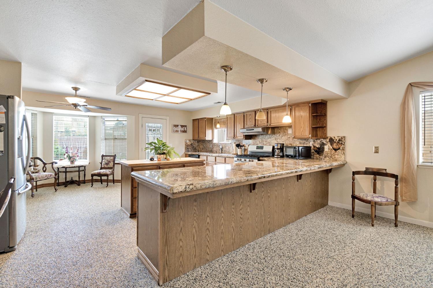 73 Devon Drive Lemoore, CA 93245 - Photo 5 of 32 a kitchen with counter and workspace