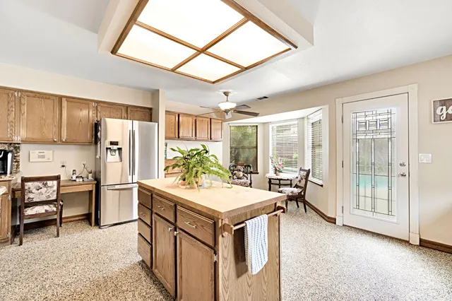 a kitchen with refrigerator cabinets and wooden floor