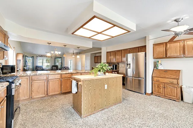 a kitchen with a refrigerator sink and stove
