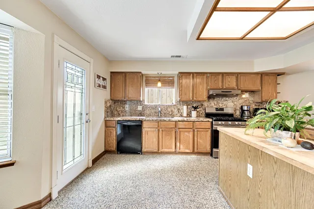 a living room with furniture a chandelier and a flat screen tv