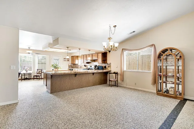 a living room with furniture and a chandelier