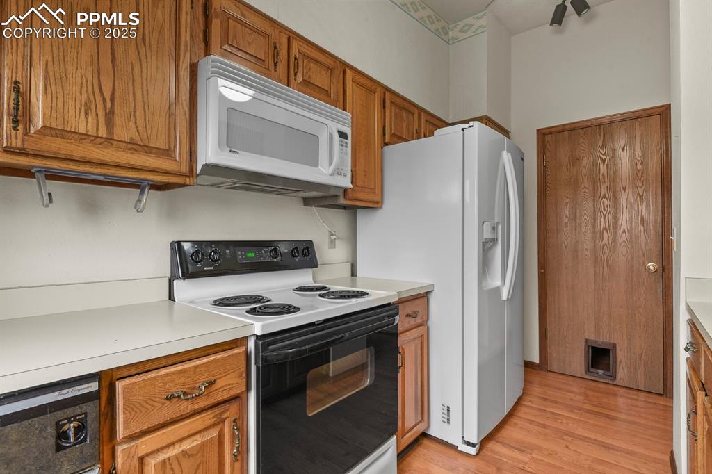 1122 Fontmore Road, Unit C Colorado Springs, CO 80904 - Photo 14 of 31 a kitchen with stainless steel appliances granite countertop a refrigerator and a stove top oven