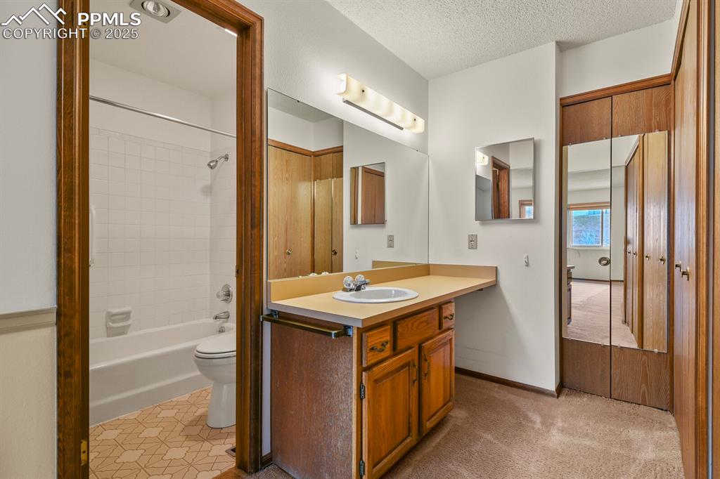 1122 Fontmore Road, Unit C Colorado Springs, CO 80904 - Photo 19 of 31 a bathroom with a granite countertop sink a mirror and a bathtub