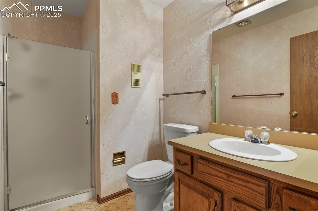 1122 Fontmore Road, Unit C Colorado Springs, CO 80904 - Photo 23 of 31 a bathroom with a sink toilet and a mirror