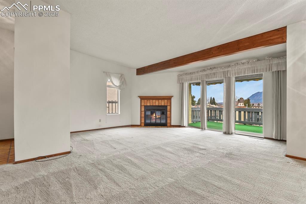1122 Fontmore Road, Unit C Colorado Springs, CO 80904 - Photo 5 of 31 an empty room with windows and fireplace