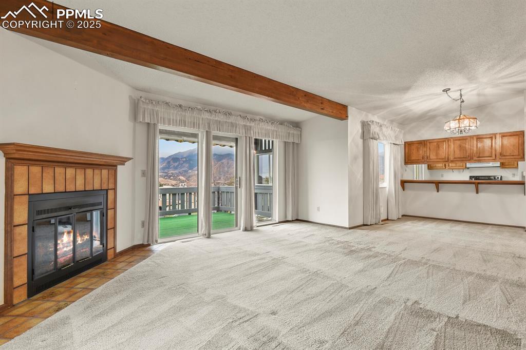 1122 Fontmore Road, Unit C Colorado Springs, CO 80904 - Photo 8 of 31 a view of an empty room with a fireplace and a window