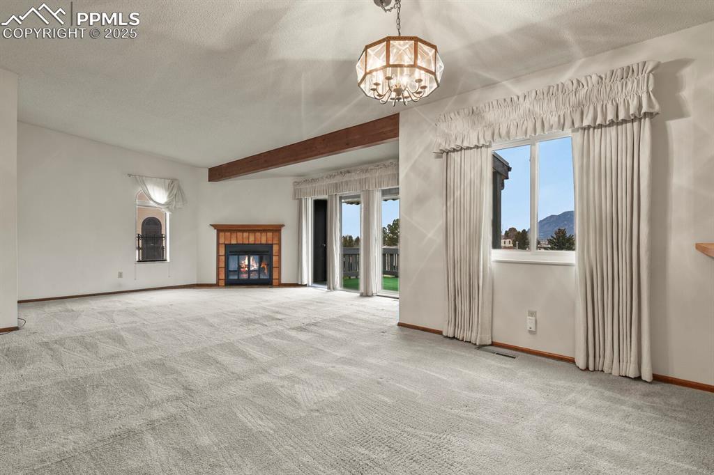1122 Fontmore Road, Unit C Colorado Springs, CO 80904 - Photo 9 of 31 a view of an empty room with a fireplace