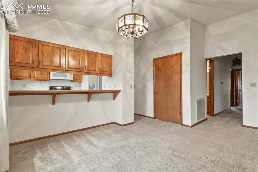 1122 Fontmore Road, Unit C Colorado Springs, CO 80904 - Photo 10 of 31 a view of kitchen with granite countertop cabinets and refrigerator