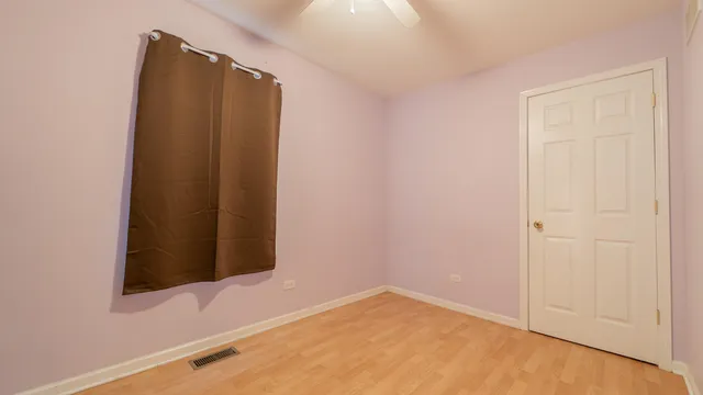 a view of a dresser with wooden floor