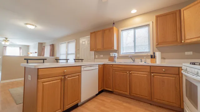 a view of a kitchen with dining room and wooden floor