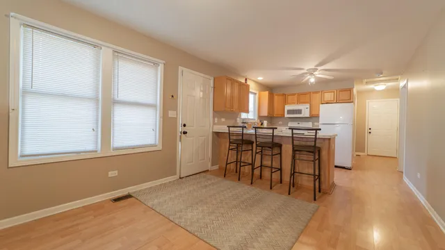 a kitchen with stainless steel appliances white cabinets and a refrigerator