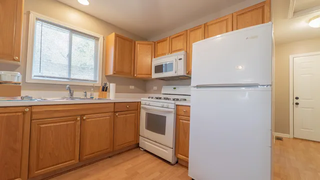 a view of a dining room with furniture and a chandelier