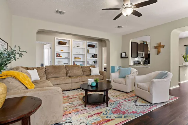 a living room with furniture and wooden floor