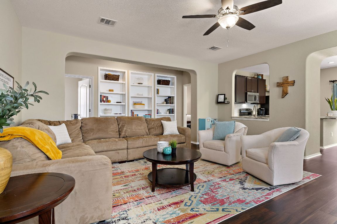 a living room with furniture and wooden floor