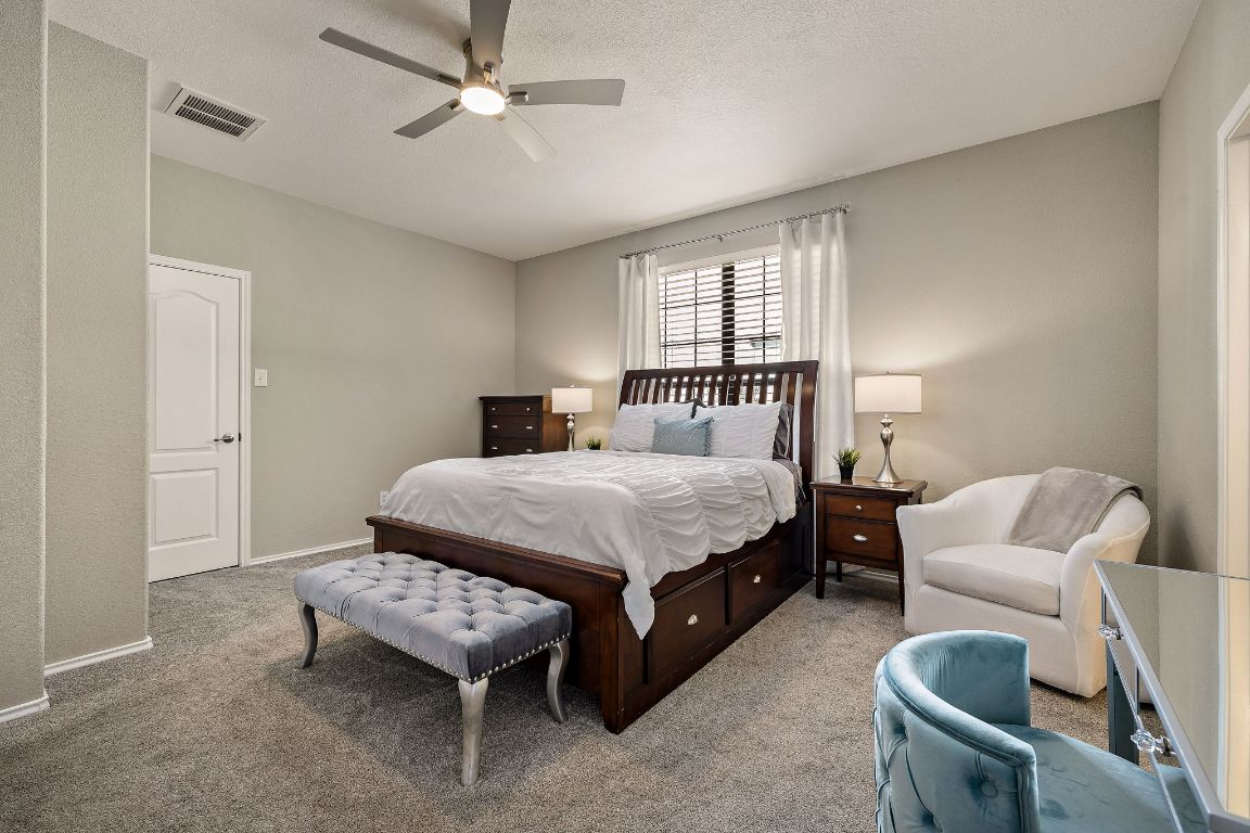 408 Tyree Road Cedar Park, TX 78613 - Photo 14 of 25 a spacious bedroom with a bed and a couch