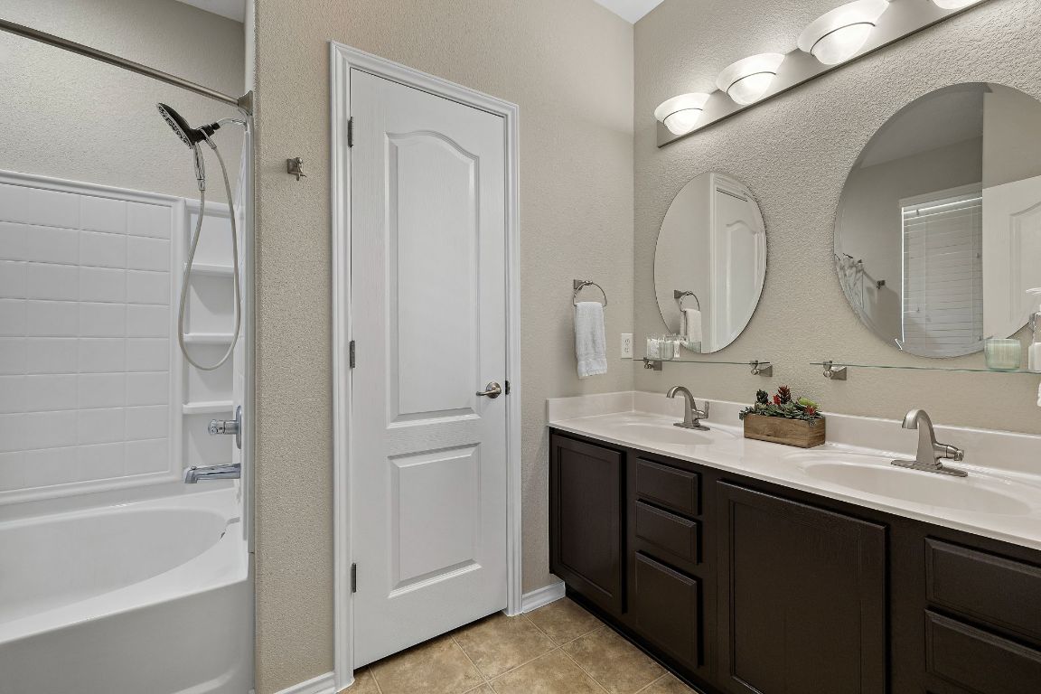 408 Tyree Road Cedar Park, TX 78613 - Photo 16 of 25 a bathroom with a double vanity sink mirror and bathtub