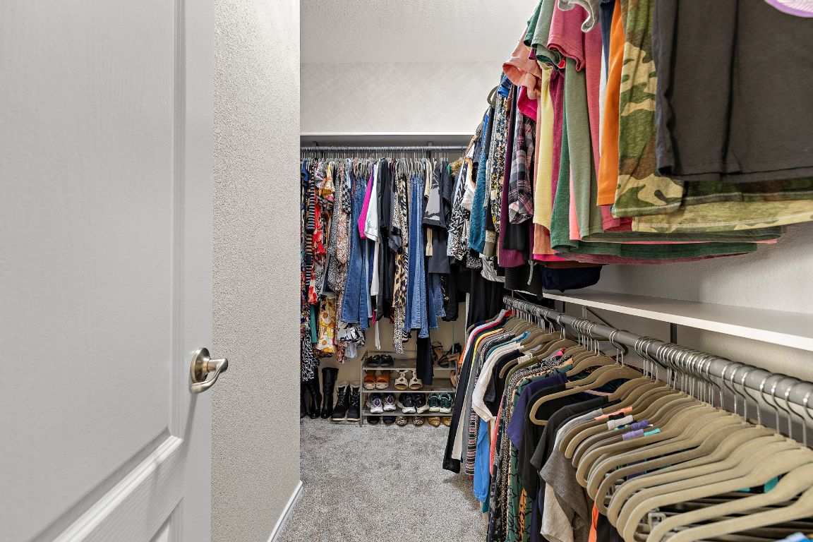 408 Tyree Road Cedar Park, TX 78613 - Photo 17 of 25 a view of walk in closet with clothes