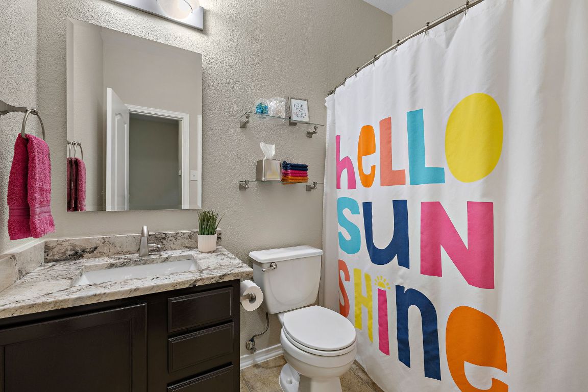 408 Tyree Road Cedar Park, TX 78613 - Photo 20 of 25 a bathroom with a sink vanity mirror and toilet
