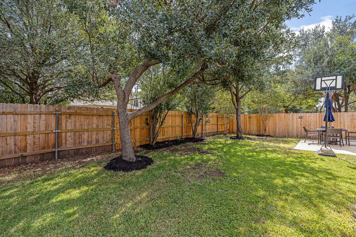 408 Tyree Road Cedar Park, TX 78613 - Photo 23 of 25 a backyard of a house with lots of green space