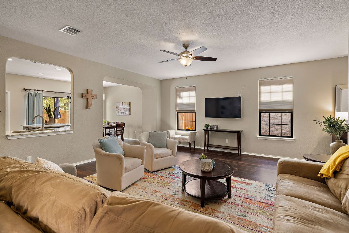 408 Tyree Road Cedar Park, TX 78613 - Photo 5 of 25 a living room with furniture a flat screen tv and a chandelier