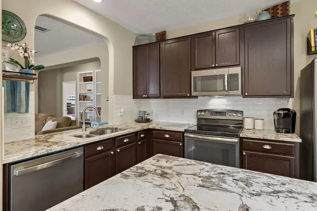 a kitchen with a sink stove and microwave