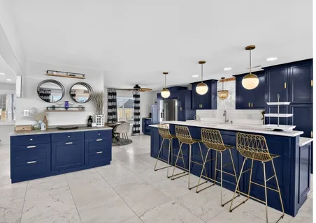 a large kitchen with a table and a clock on the wall