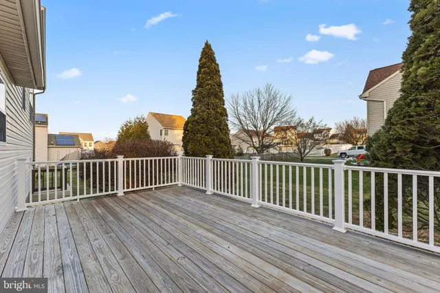 a view of balcony with wooden floor and fence