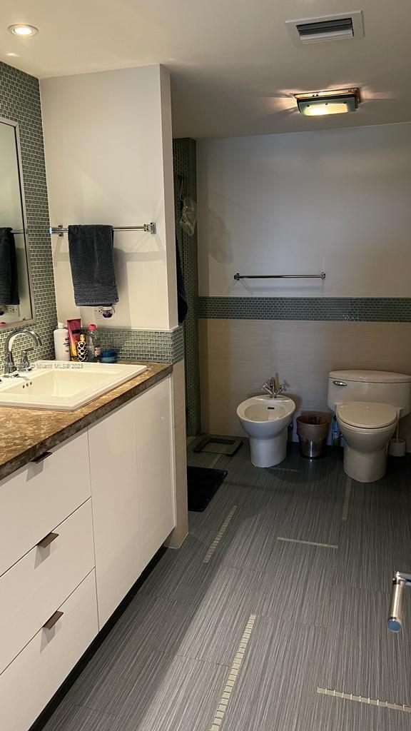 199 Ocean Ln Drive, Unit 1206 Key Biscayne, FL 33149 - Photo 9 of 12 a bathroom with a toilet sink and mirror