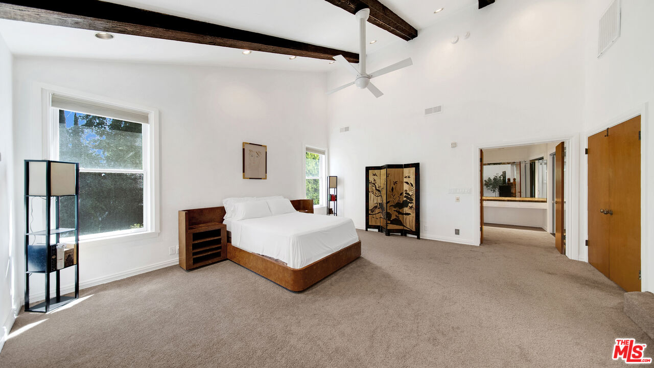 2312 Kimridge Road Beverly Hills, CA 90210 - Photo 40 of 60 a spacious bedroom with a bed and a couch