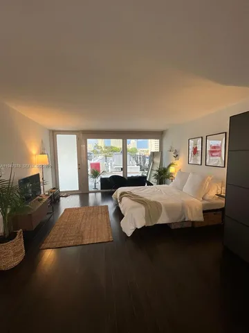 a bed room with a bed and a large window