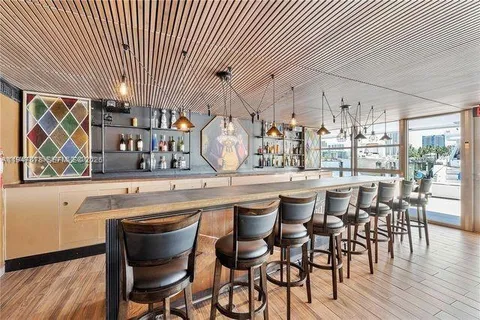 a kitchen with stainless steel appliances granite countertop sink cabinets and wooden floor