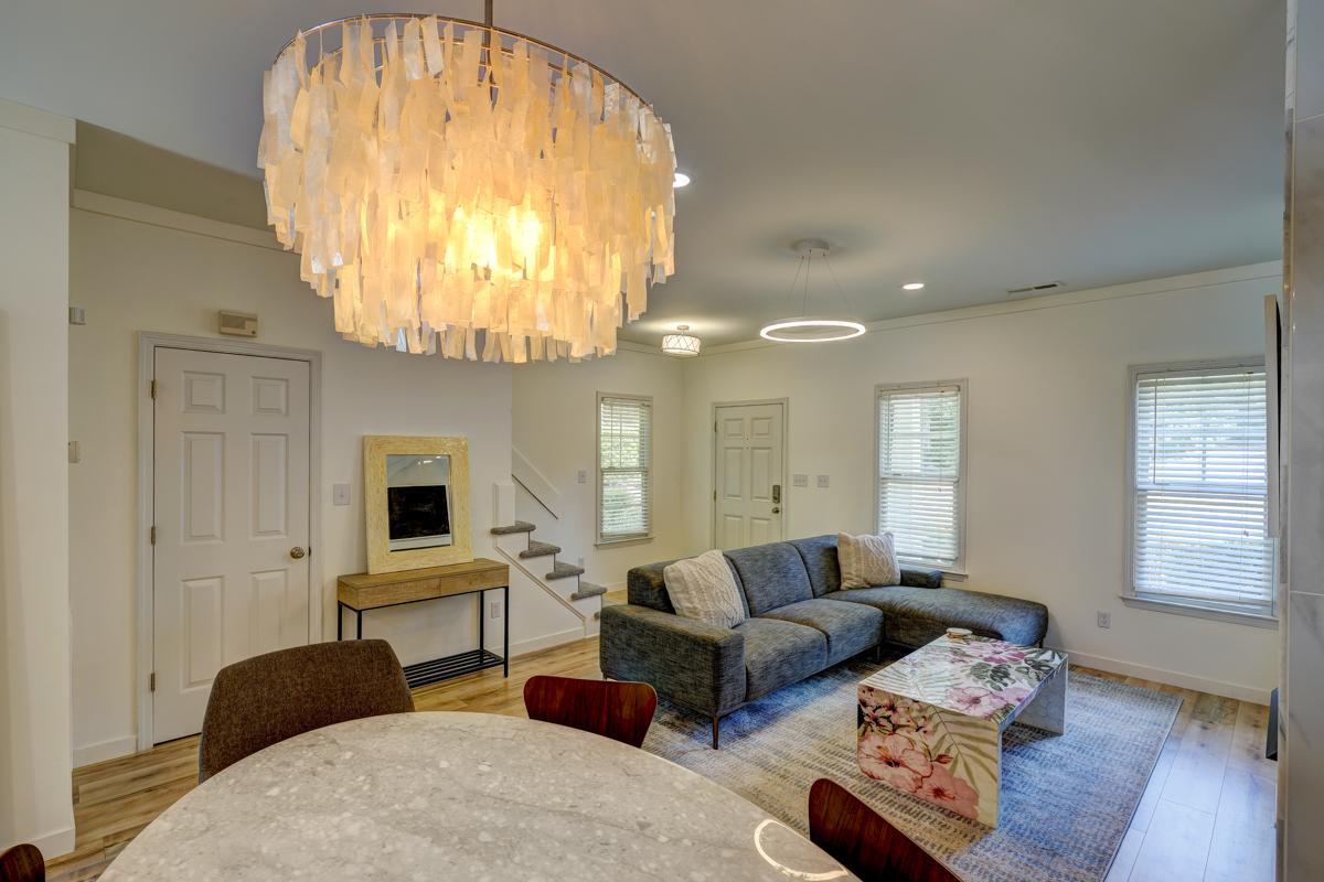 20017 Roark Hoey Loop Chapel Hill, NC 27517 - Photo 14 of 44 a living room with furniture and a chandelier