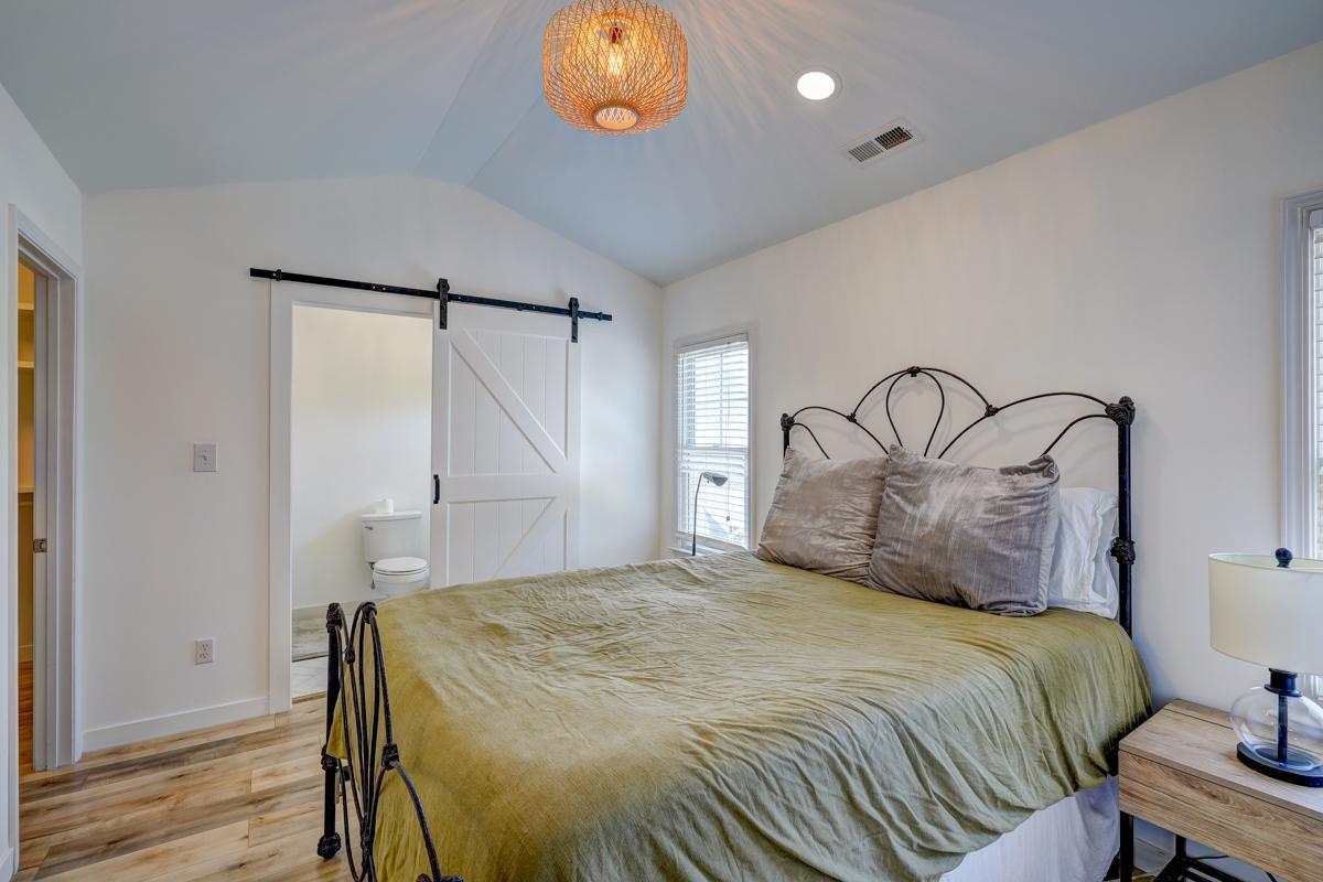 20017 Roark Hoey Loop Chapel Hill, NC 27517 - Photo 24 of 44 a bedroom with a bed and a chandelier