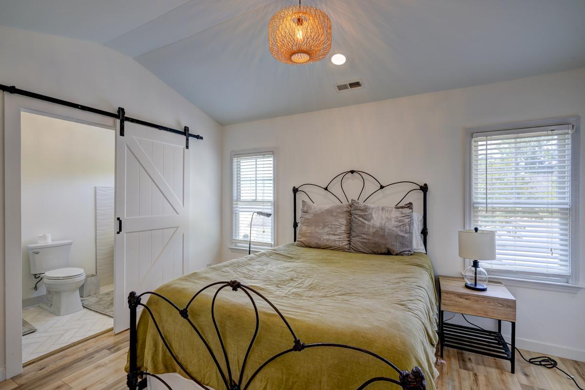 20017 Roark Hoey Loop Chapel Hill, NC 27517 - Photo 26 of 44 a bedroom with a bed and a chandelier