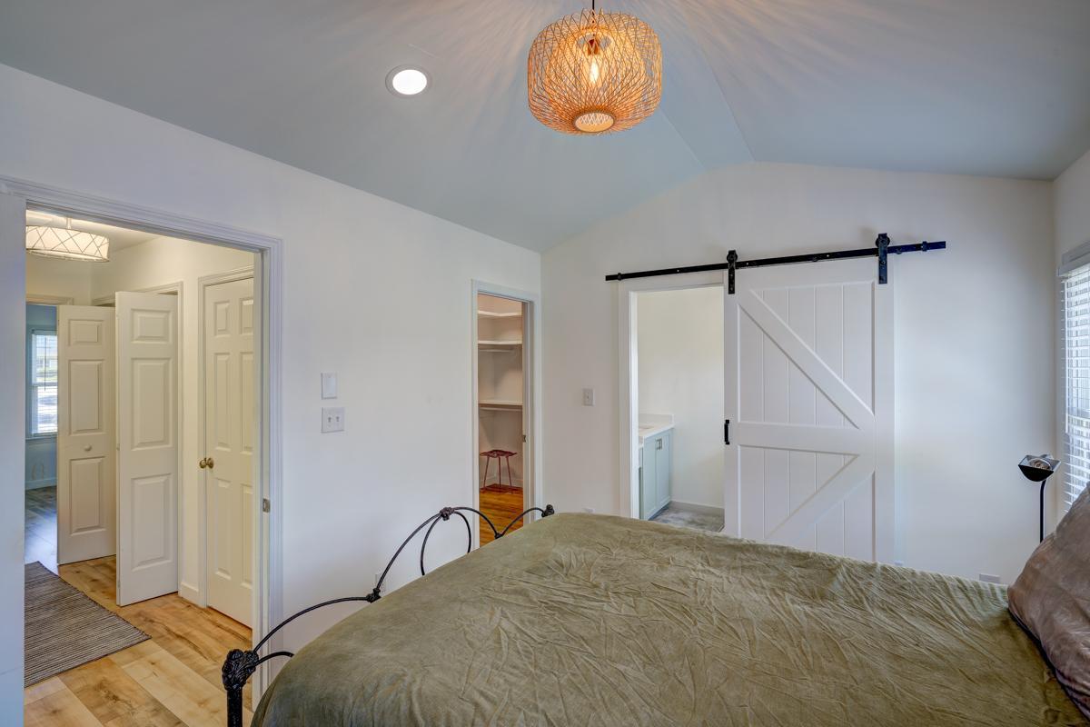 20017 Roark Hoey Loop Chapel Hill, NC 27517 - Photo 28 of 44 a bedroom with a bed and a chandelier