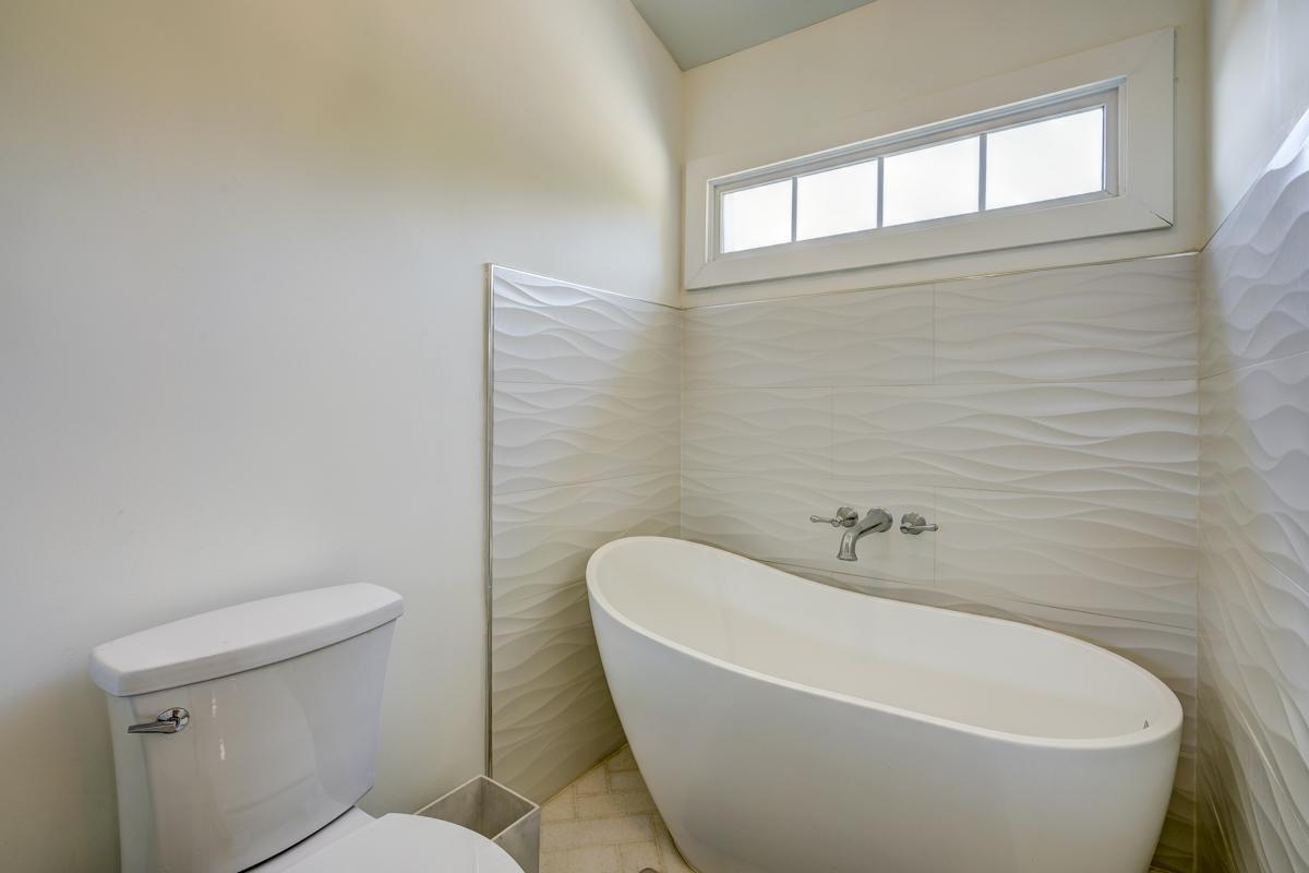 20017 Roark Hoey Loop Chapel Hill, NC 27517 - Photo 30 of 44 a white bath tub sitting next to a white toilet