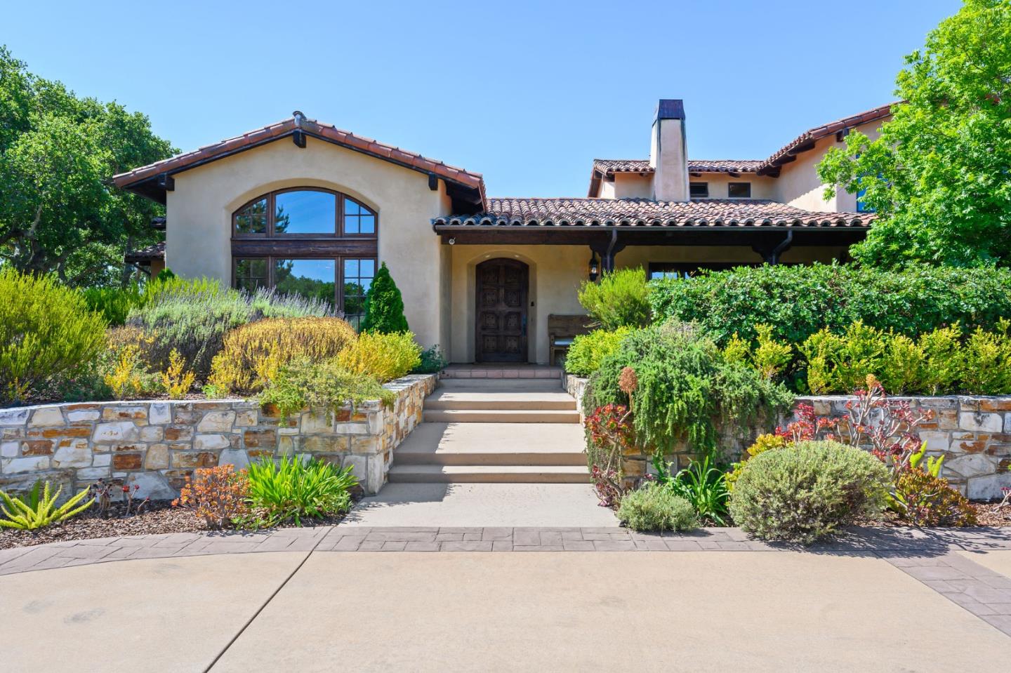 960 Laureles Grade Carmel Valley, CA 93924 - Photo 4 of 76 a front view of a house with a yard