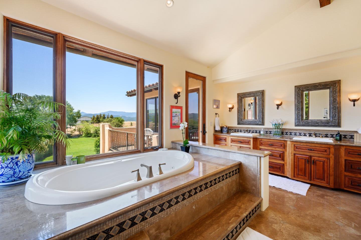 960 Laureles Grade Carmel Valley, CA 93924 - Photo 45 of 76 a spacious bathroom with a granite countertop tub and a large window