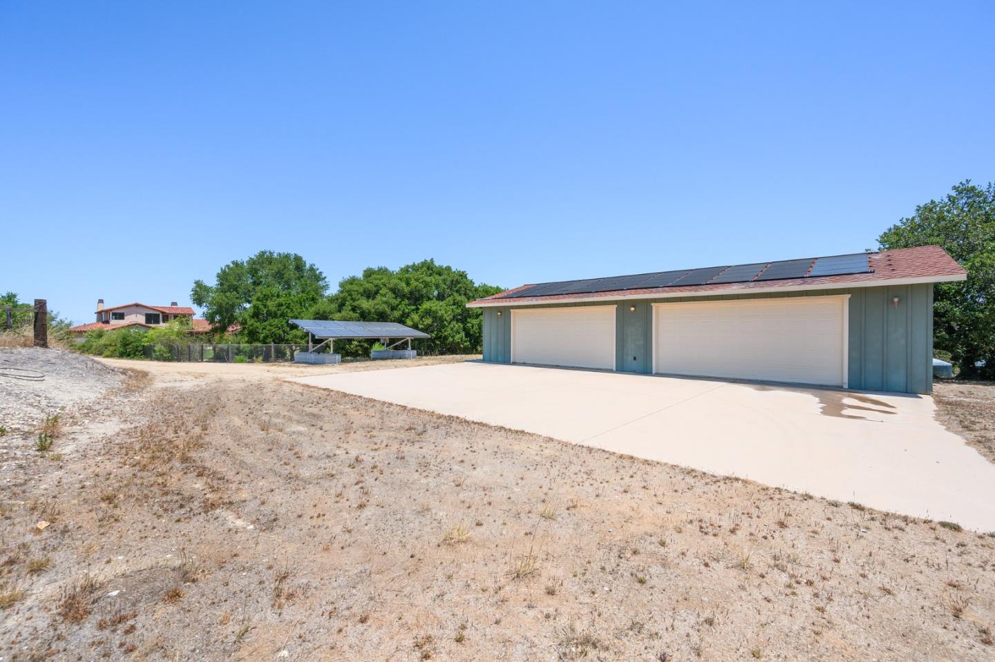 960 Laureles Grade Carmel Valley, CA 93924 - Photo 71 of 76 a front view of a house with a yard and garage